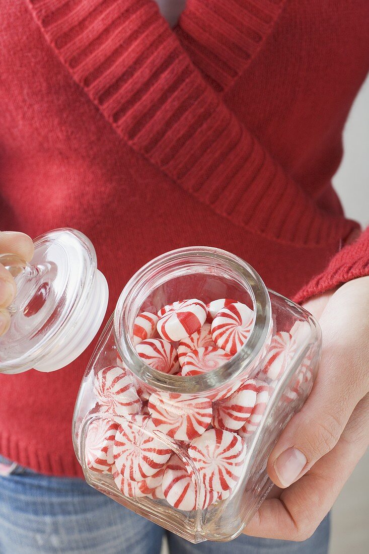 Hand hält Glas mit Starlite Mints (Minzbonbons, USA)