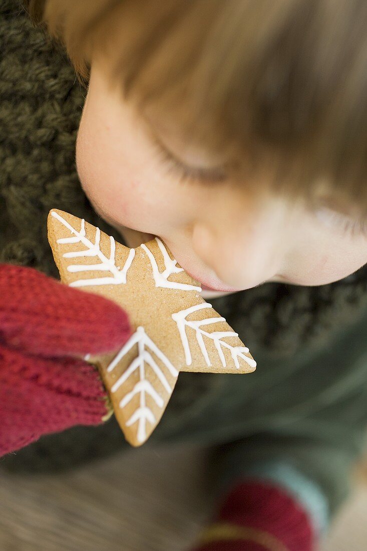 Child biting into gingerbread star