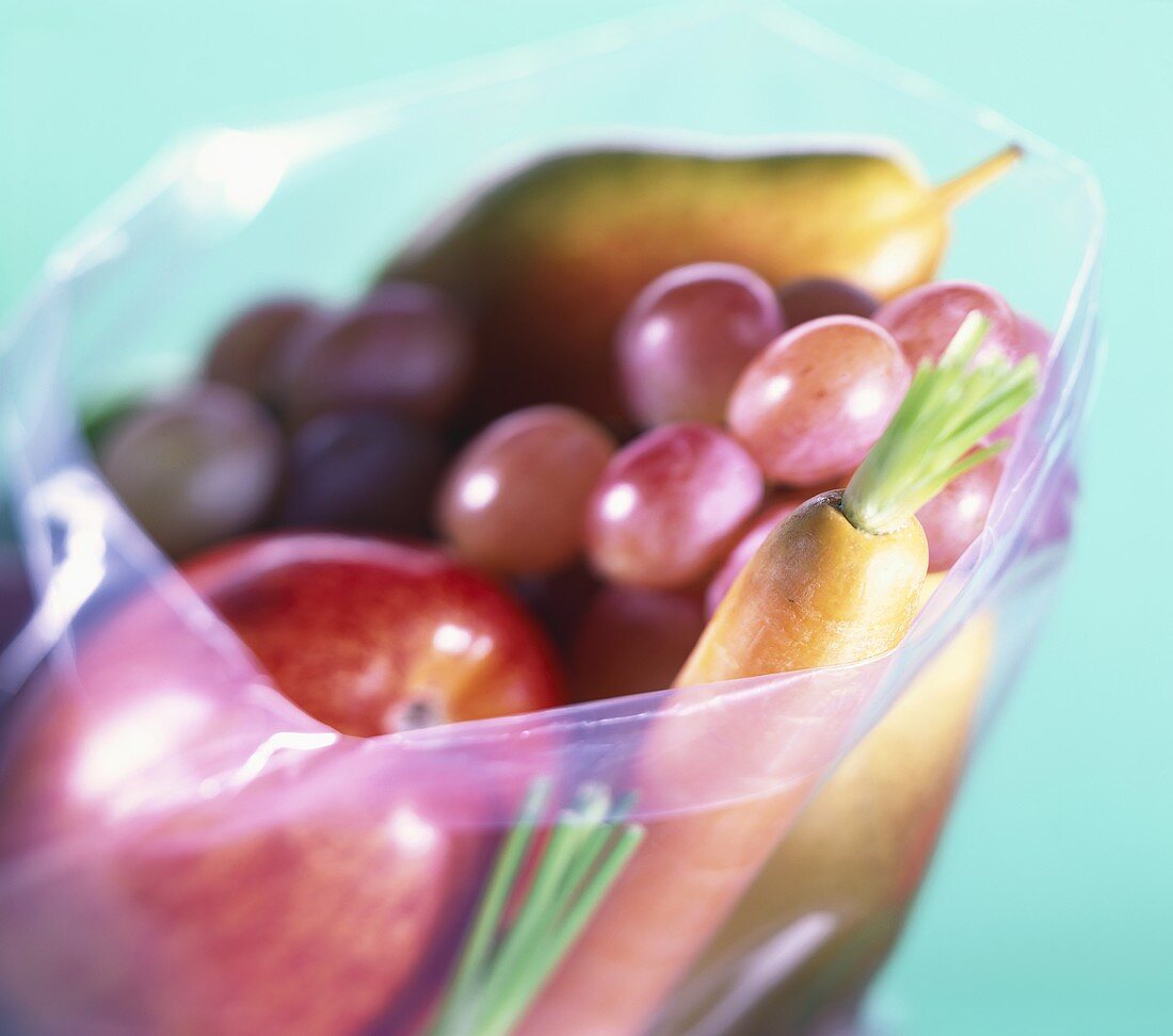 Apple, grapes, pear and carrots in freezer bag