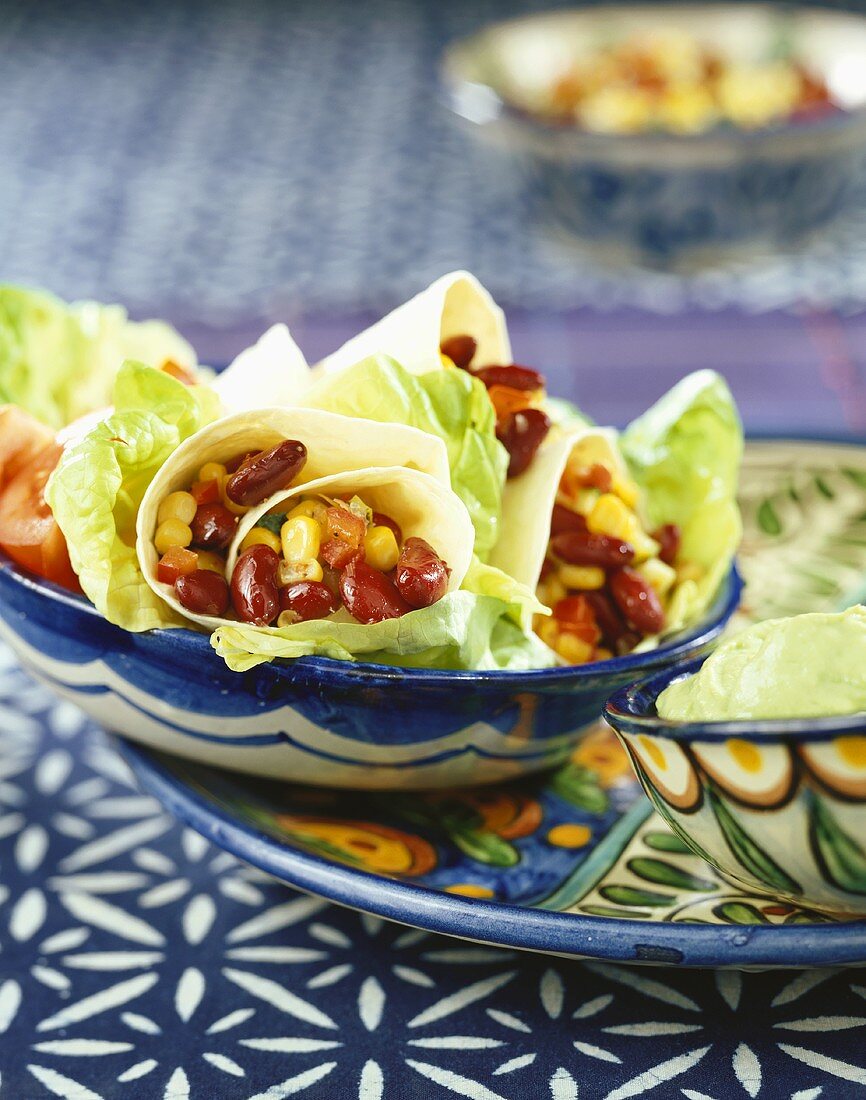 Tortillas with bean and sweetcorn filling, guacamole