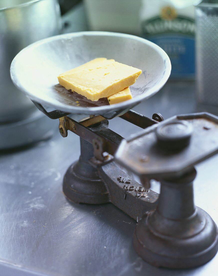 Two slices of hard cheese on old scales
