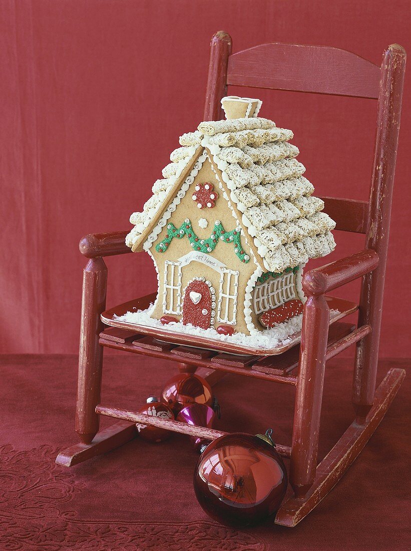 Gingerbread house on red child's chair