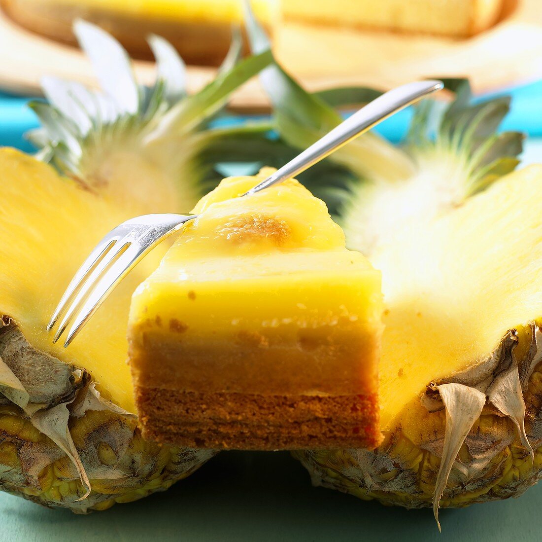 Piece of pineapple cake on two pineapple halves