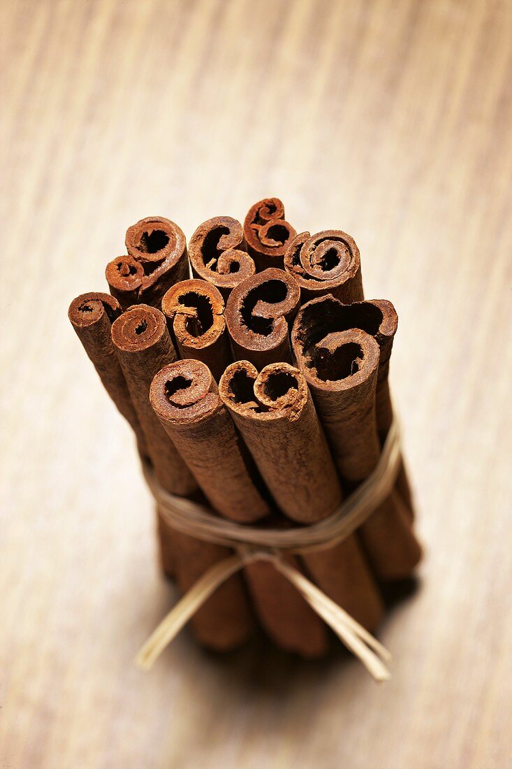 Cinnamon sticks on wooden background