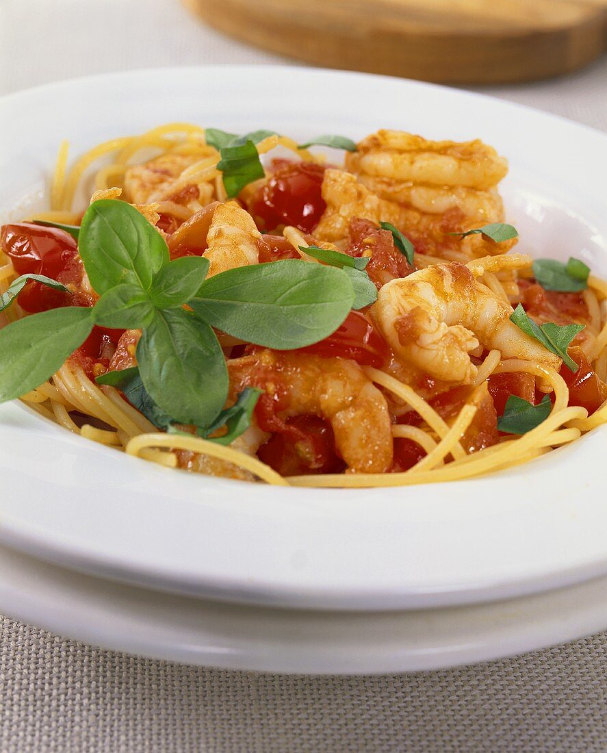 Spaghetti with shrimps, tomato sauce and basil