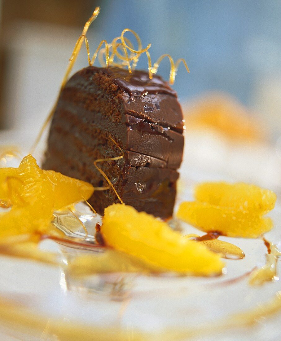 A piece of chocolate cake with oranges