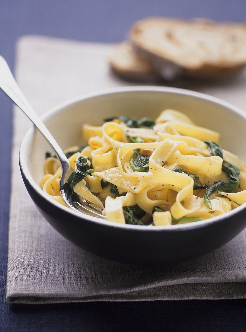 Ribbon pasta with spinach and pine nuts