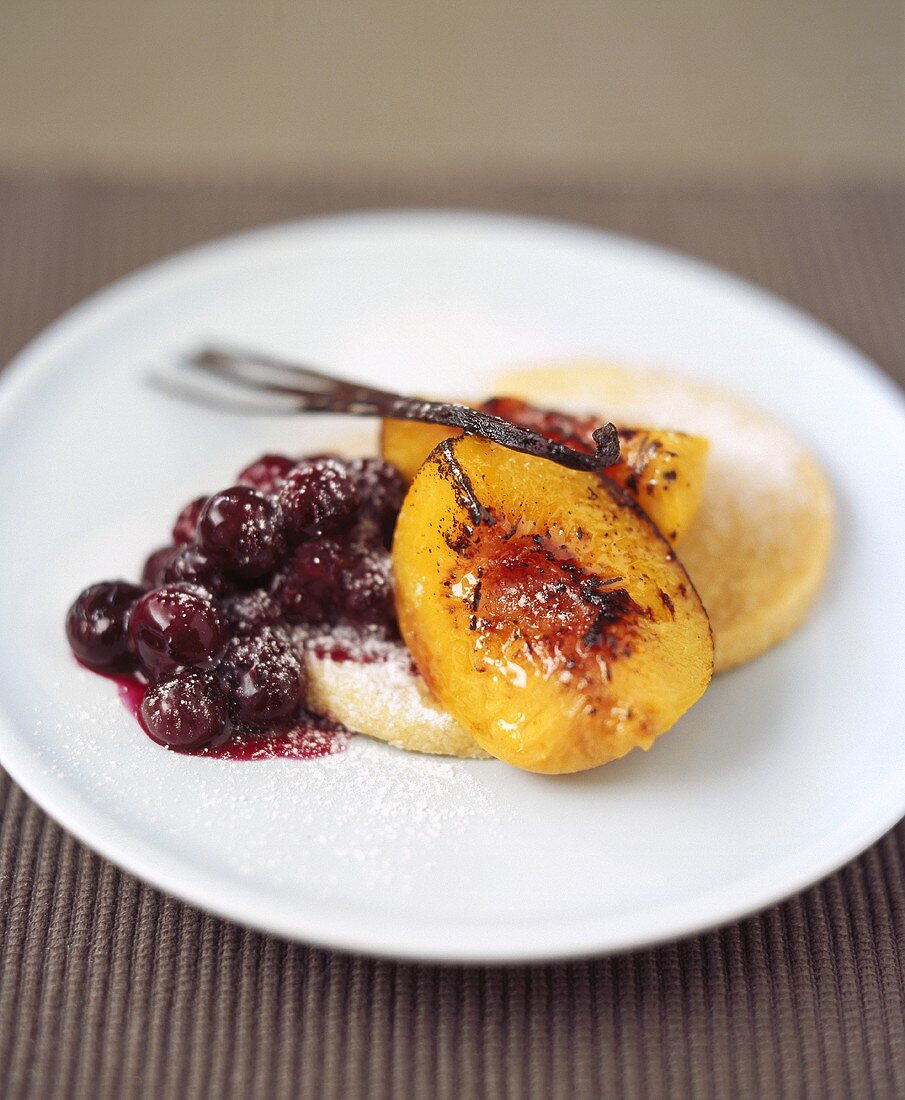Baked peach with cherry compote and semolina biscuits