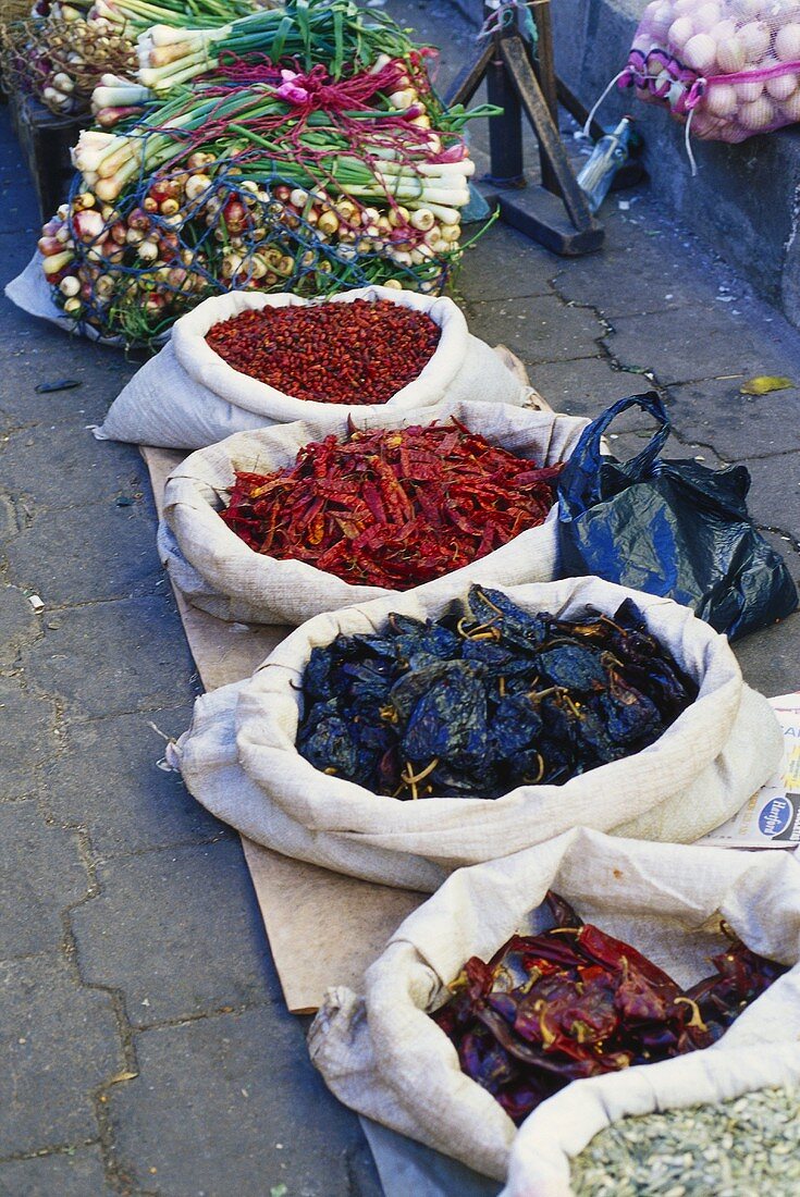 Dried chili peppers in sacks at market (Mexico)