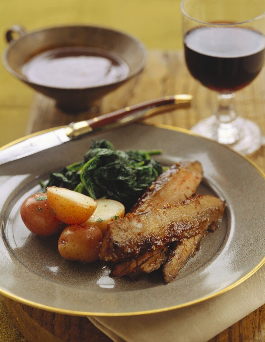 Pork ribs with new potatoes and spinach