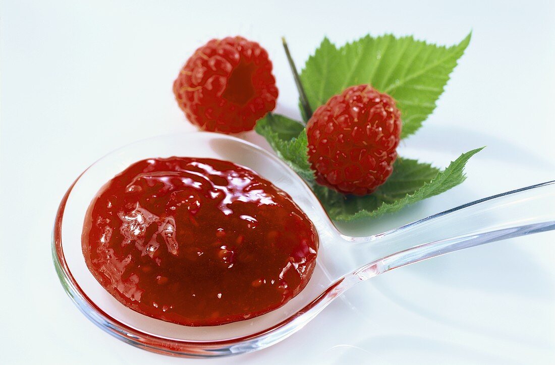 Raspberry jam on plastic spoon