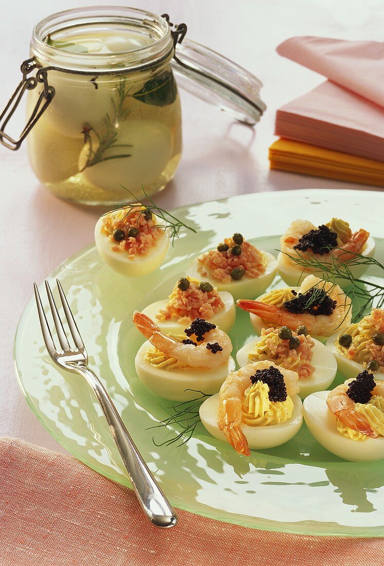 Eggs stuffed with shrimps & with ham & pickled eggs in jar