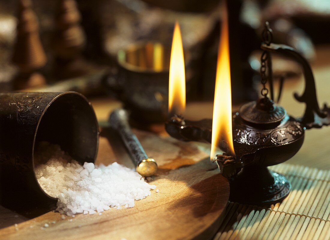 Coarse sea salt with mortar and oil lamp