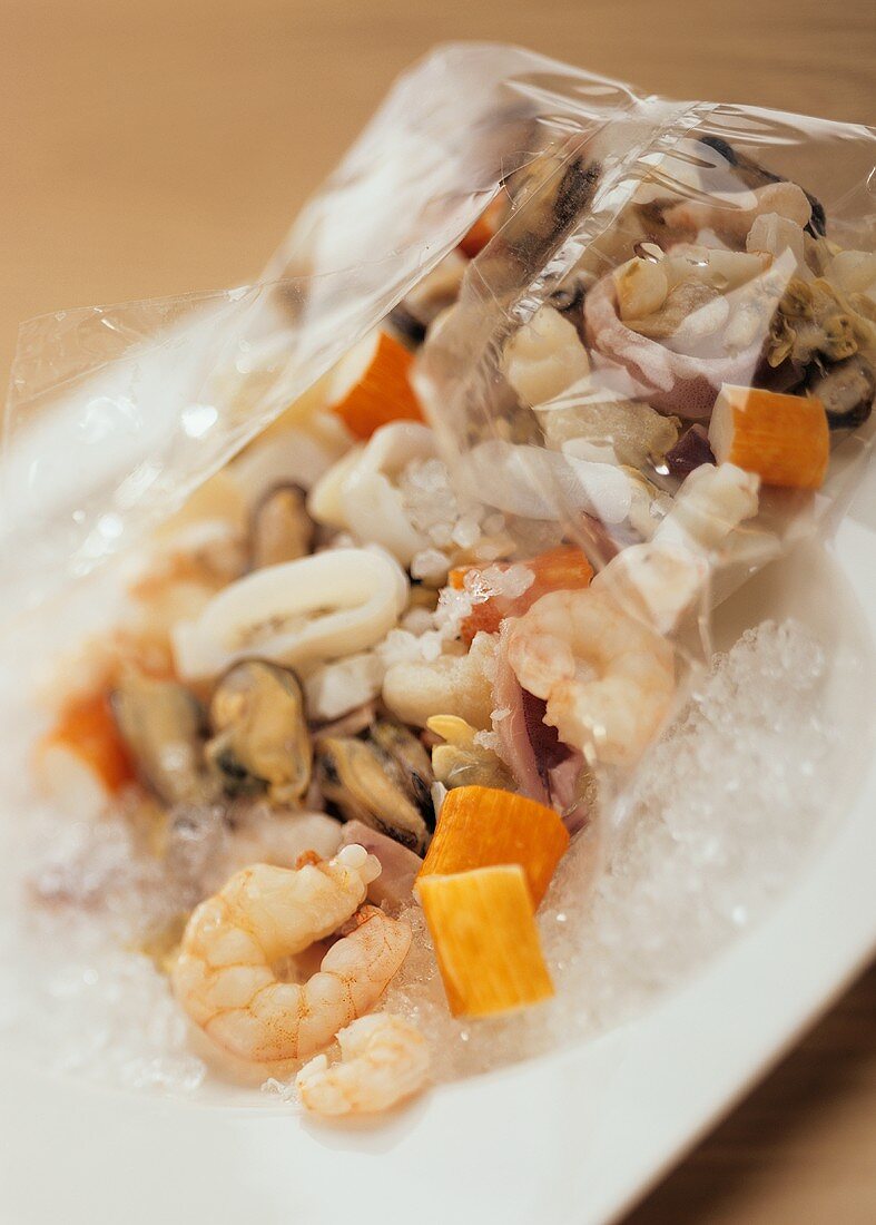 Mixed seafood in clingfilm on crushed ice