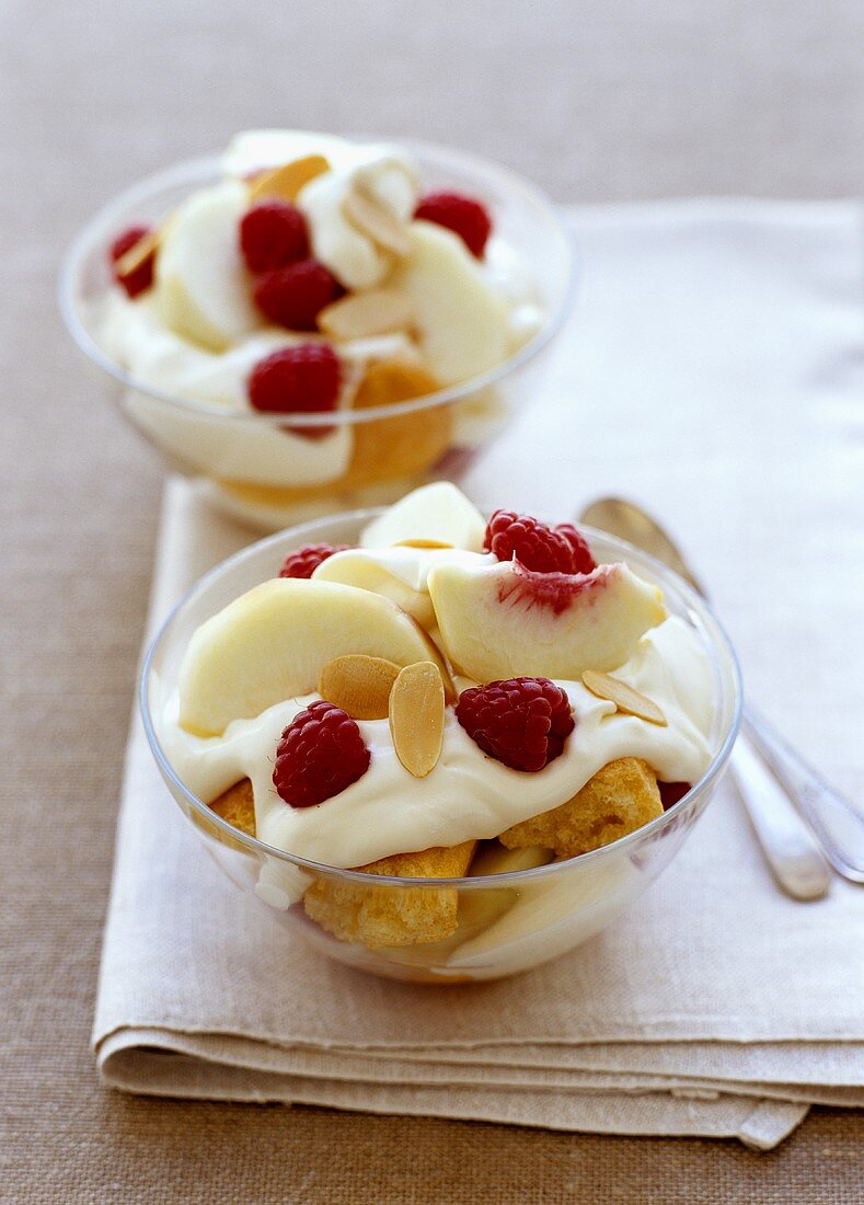 Peach and yoghurt trifle garnished with raspberries