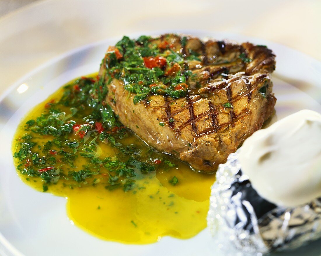 Barbecued beef steak with spicy herb sauce