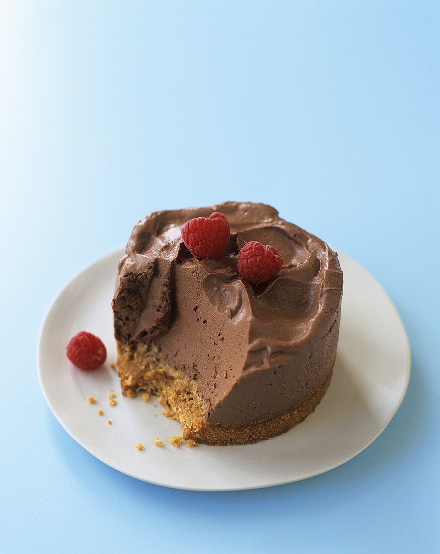 Small chocolate mousse cake with raspberries