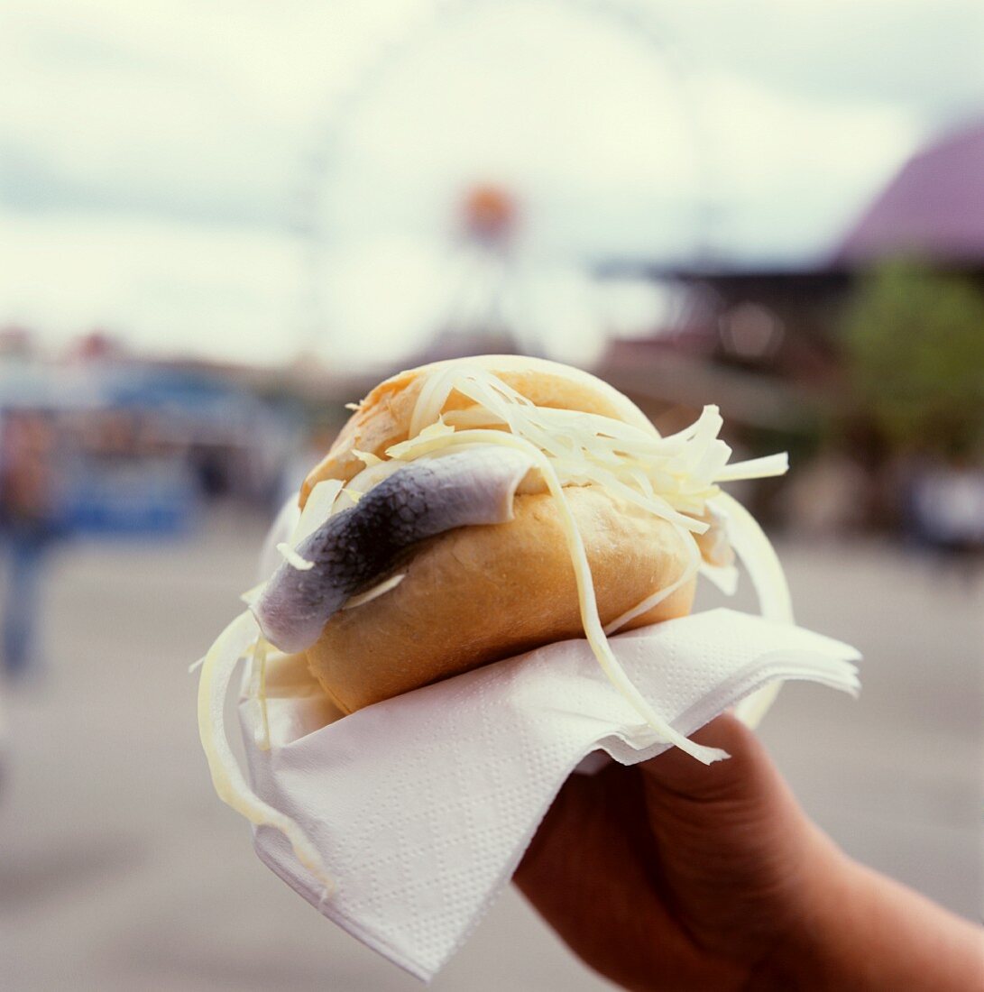 Hand holding fish roll at October Fest