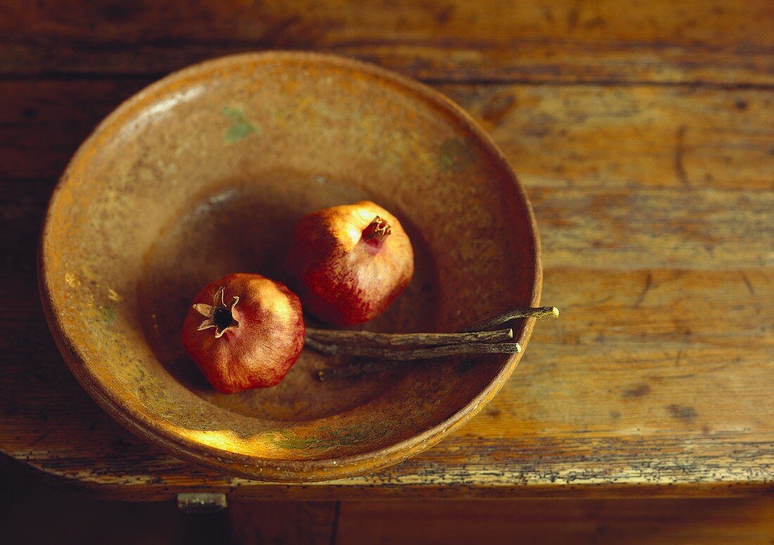 Two pomegranates in a bowl