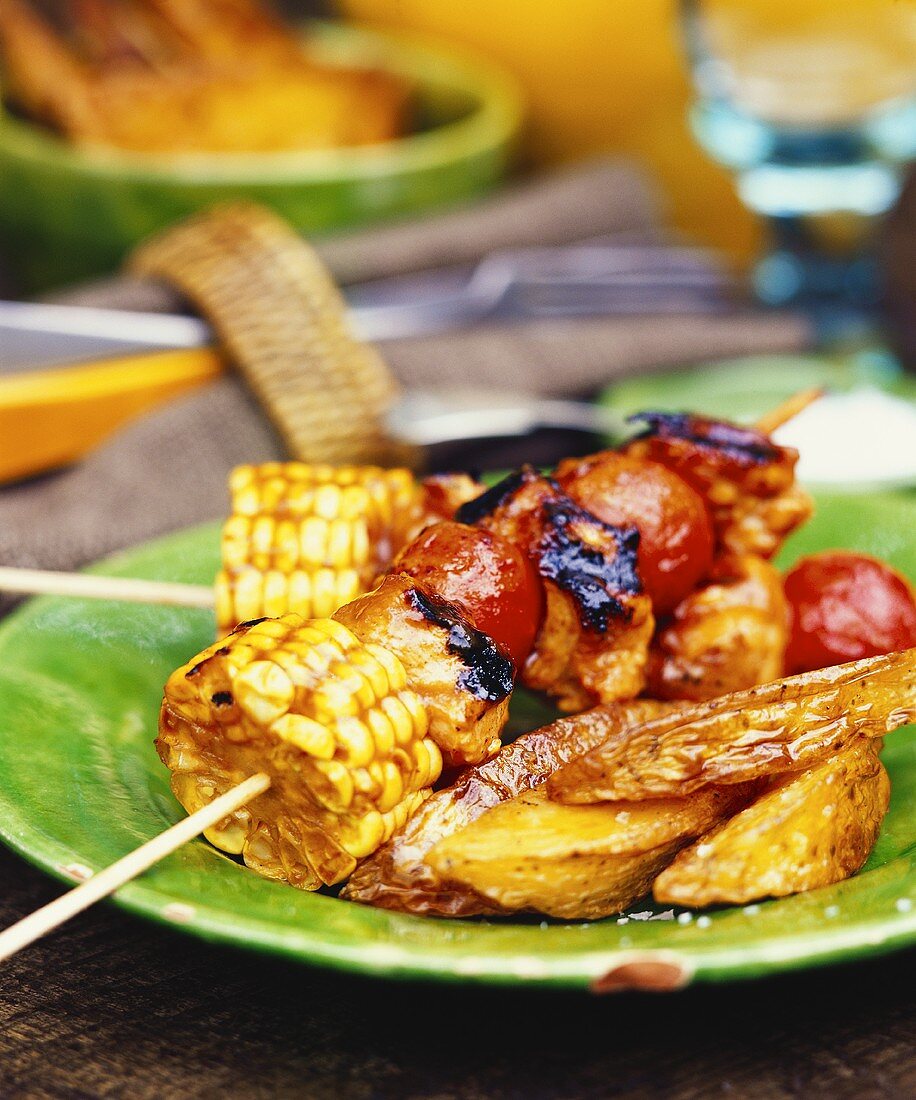 Barbecued vegetable kebabs and potato wedges