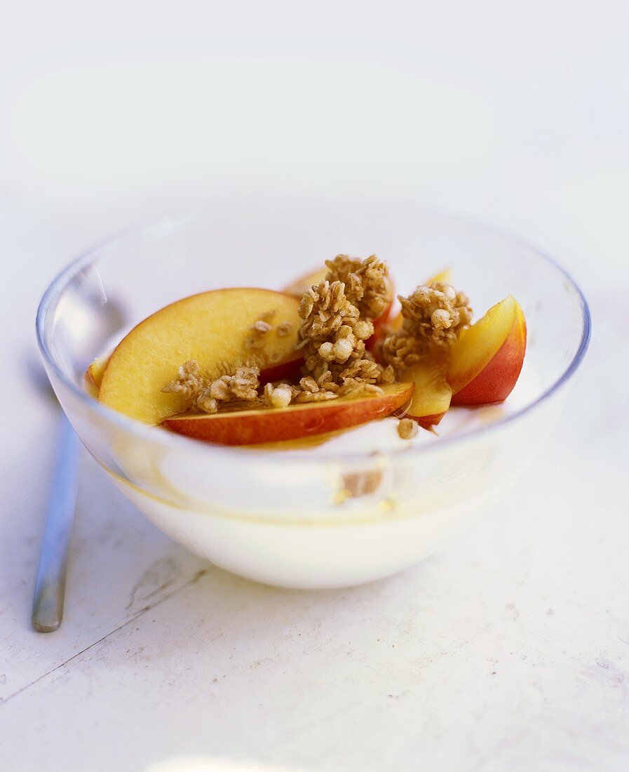 Yoghurt muesli with apple in a glass bowl