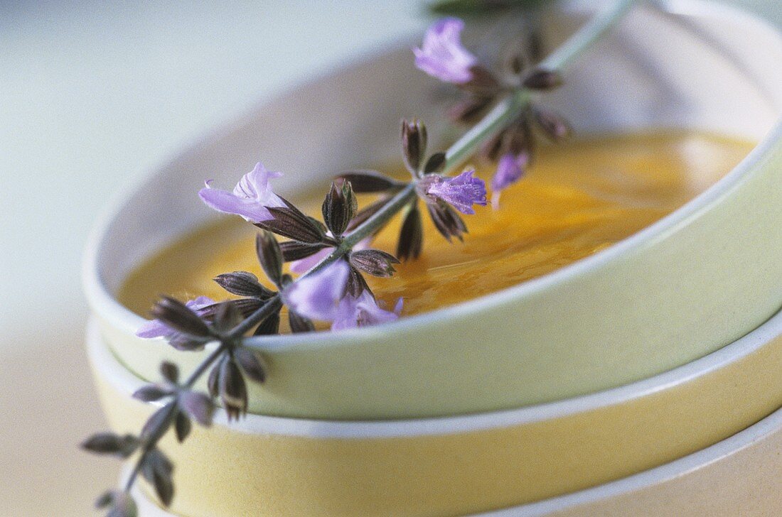 Creamed carrot soup with sage flowers