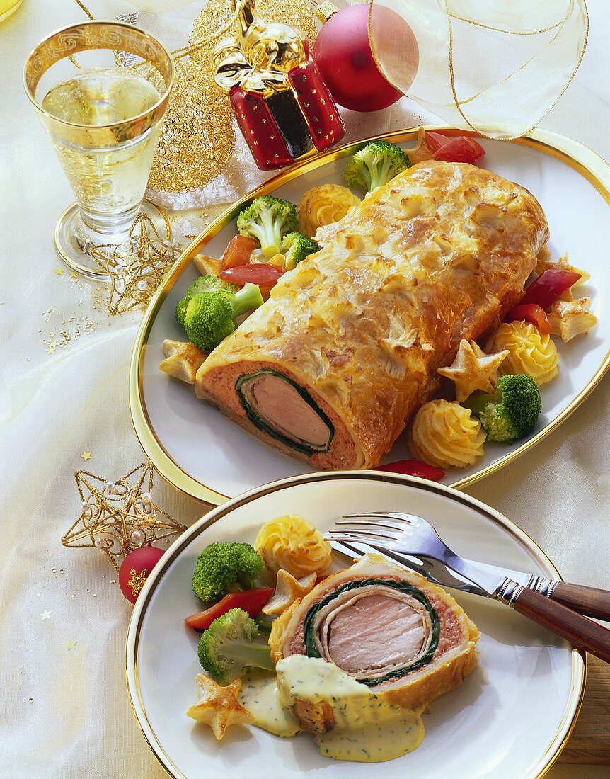 Beef Wellington, a piece cut off, with vegetables