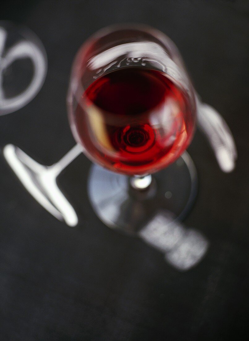 A glass of red wine on a grey background