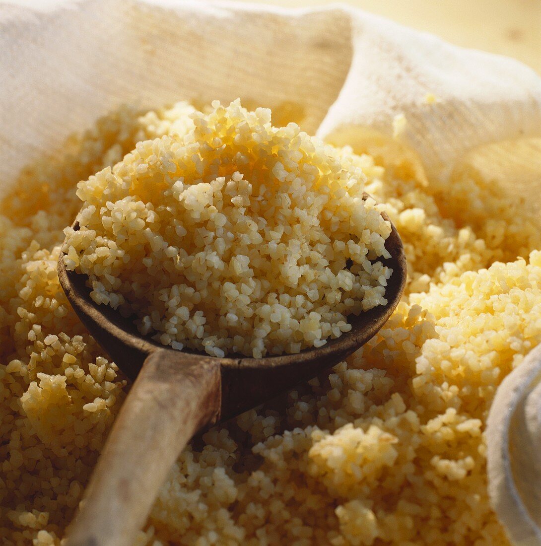 Wooden spoon in steamed couscous