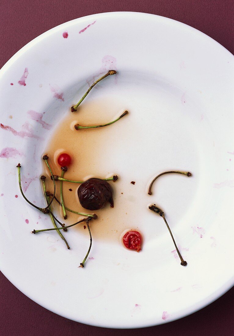 Plate with cherry stalks and remains