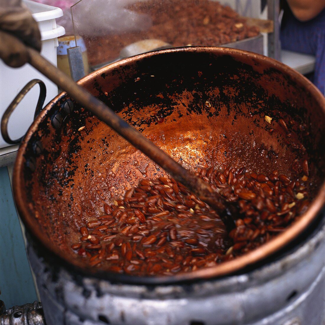Roasting almonds at market stall