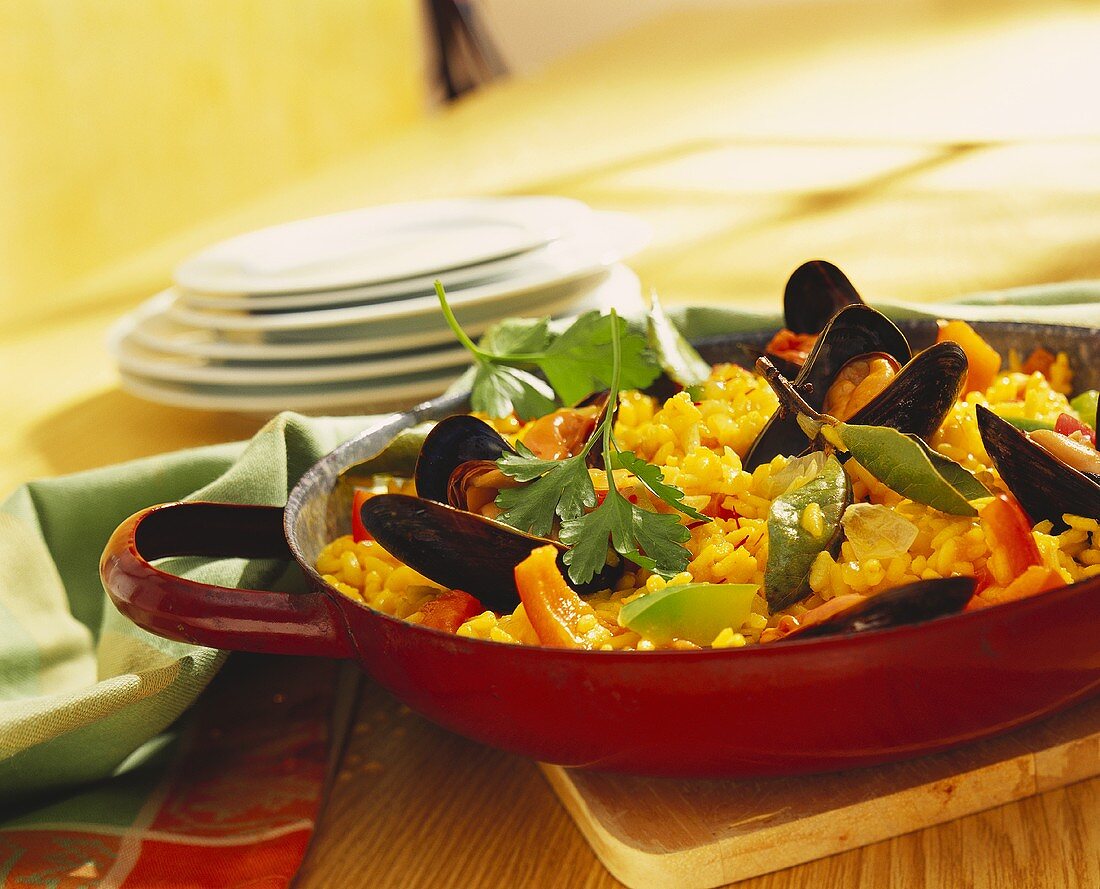 Paella with mussels in frying pan
