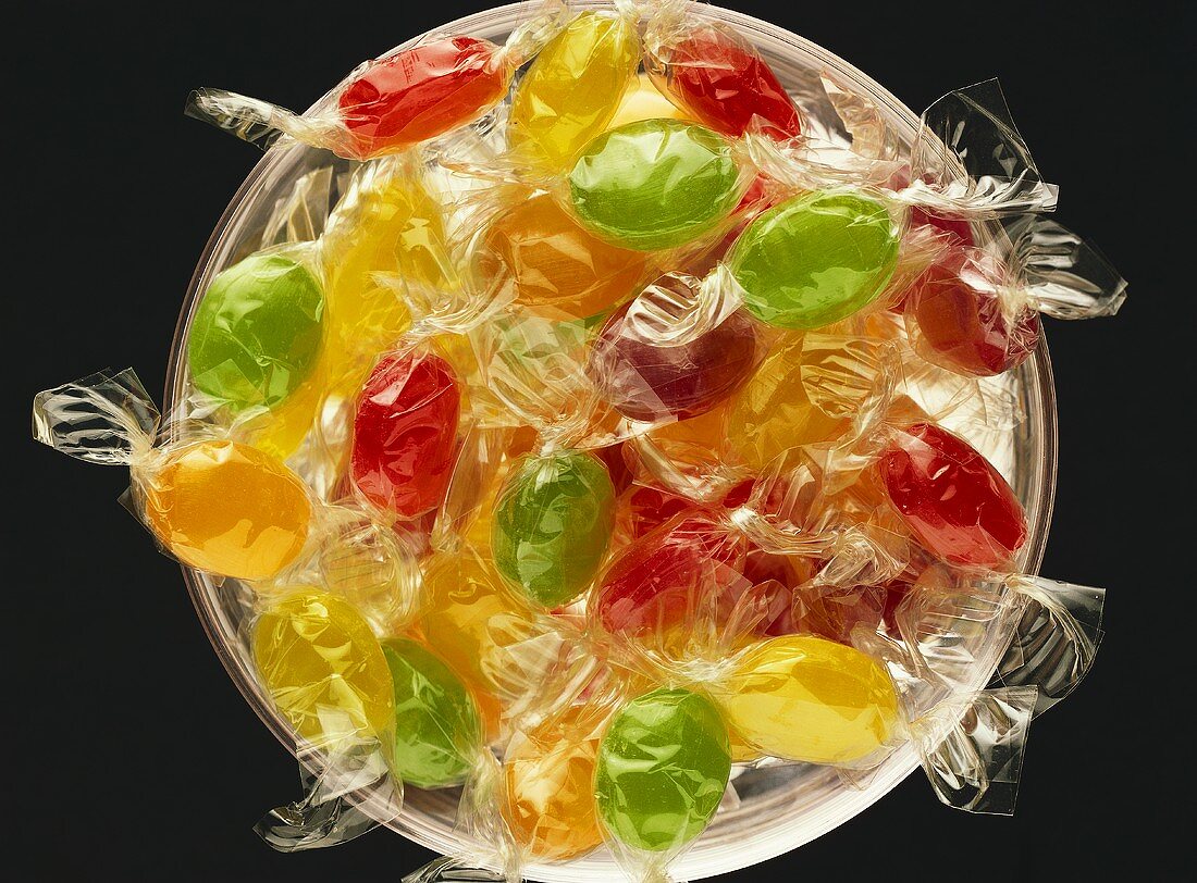 Coloured sweets, wrapped in cellophane, in a bowl