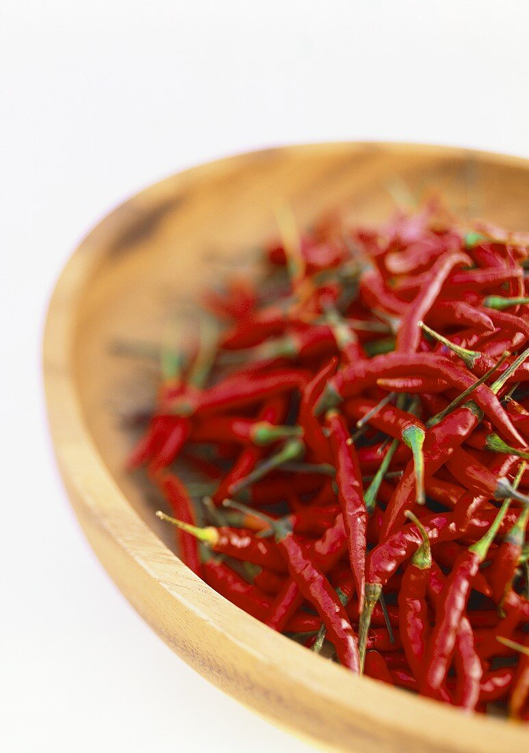 Red chili peppers in wooden bowl