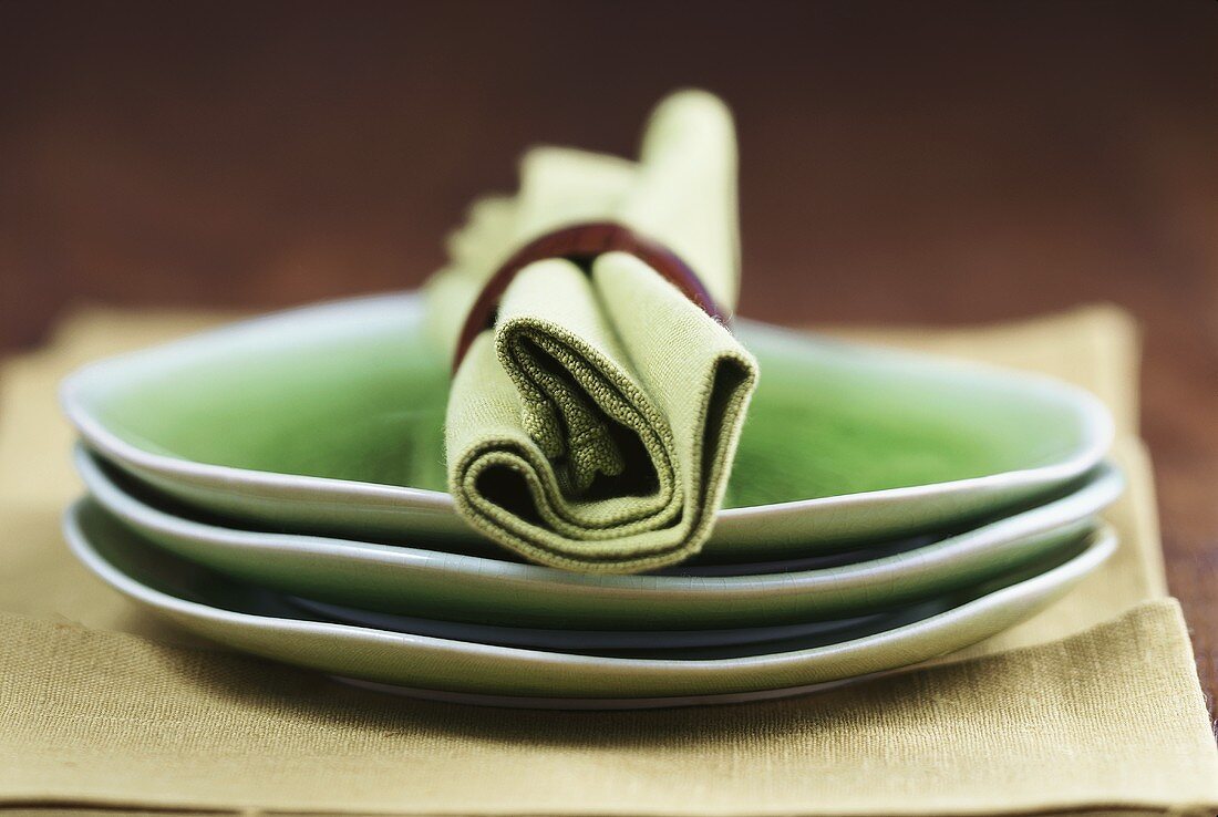 Green plates with green fabric napkin