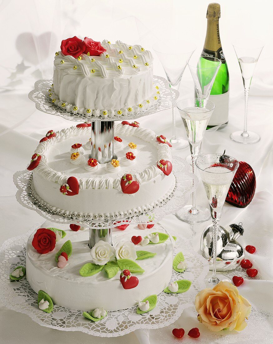 Three-tiered wedding cake with champagne glasses