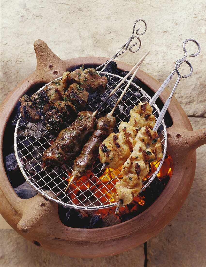 Assorted meat kebabs on a barbecue
