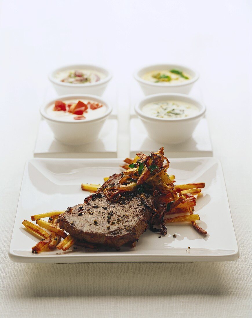 Steak and chips with various sauces