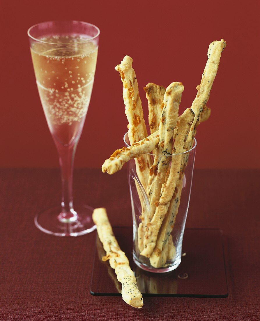 Spicy cheese sticks and a glass of champagne