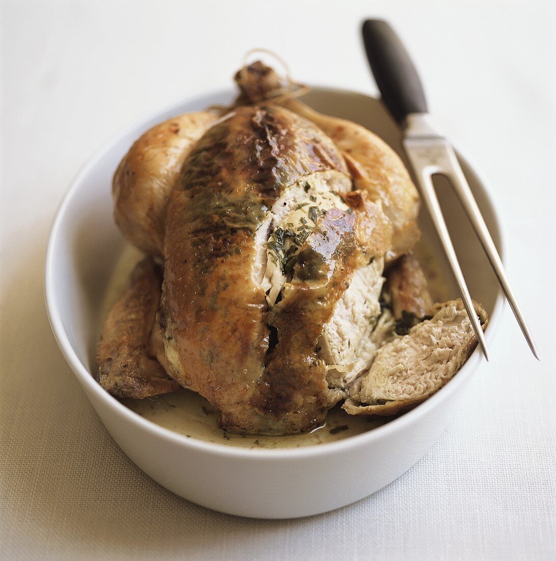 Roast chicken with meat fork