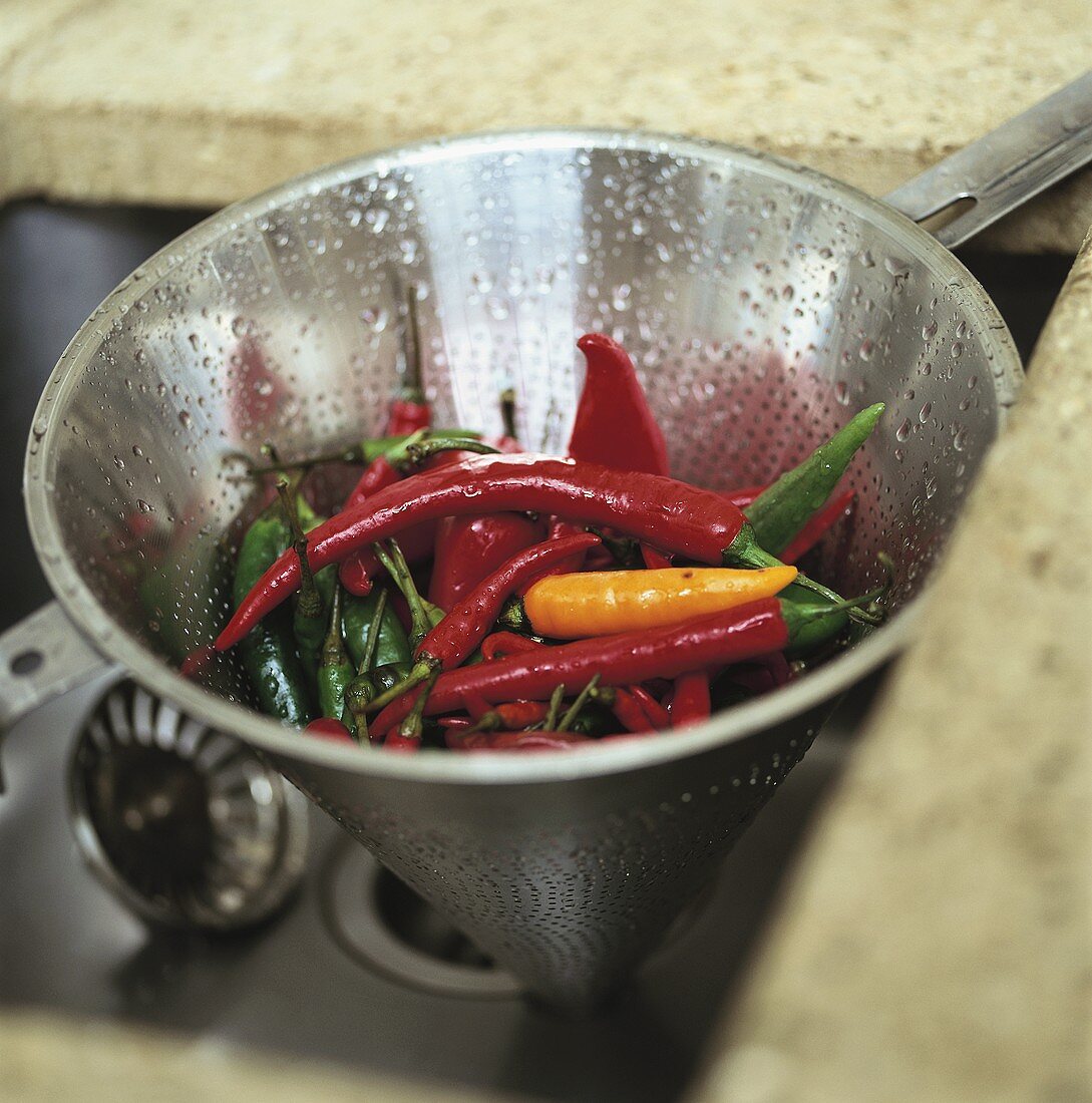 Fresh chili peppers in strainer