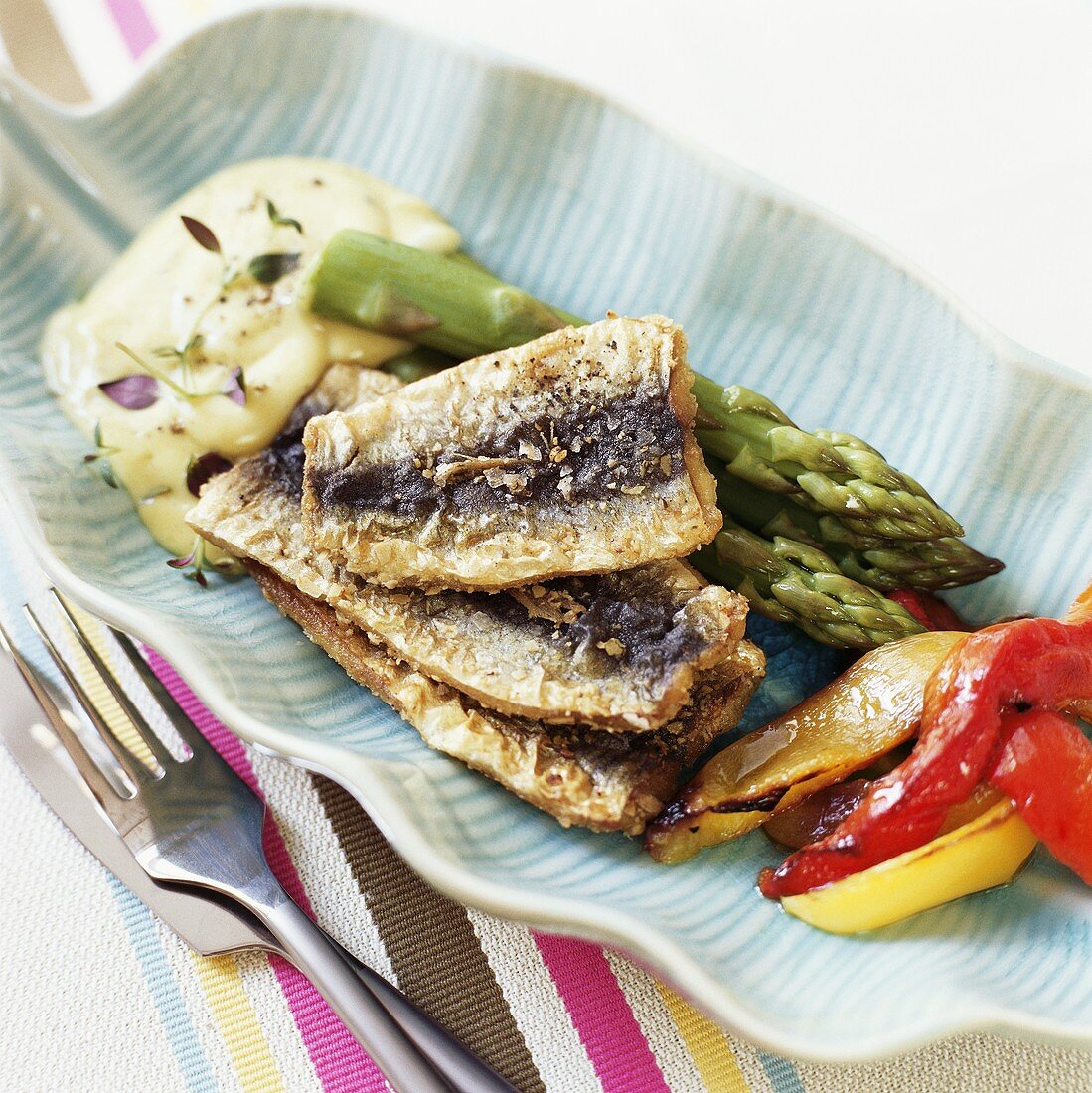 Herring with herb stuffing, asparagus, peppers and aioli