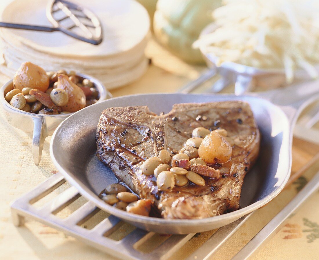 Grilled veal T-bone steak with olives