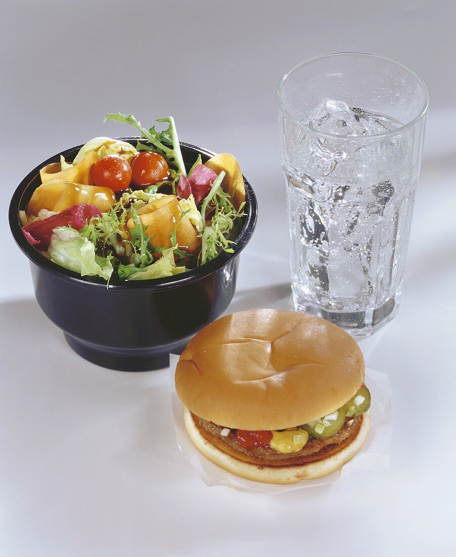 Hamburger with mixed salad and iced water
