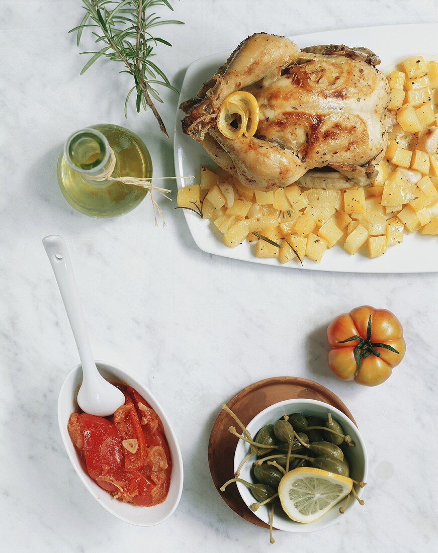 Chicken with rosemary potatoes, tomatoes and capers