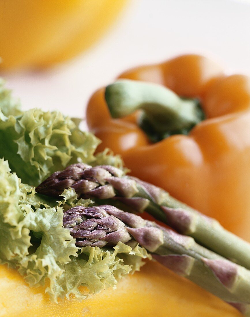 Still life with green asparagus, lollo biondo & pepper