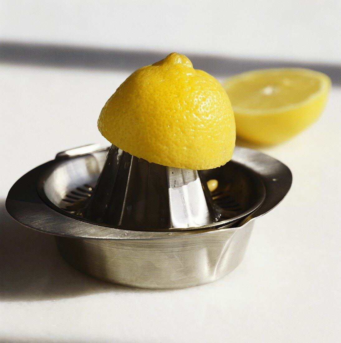 Lemon half on lemon squeezer