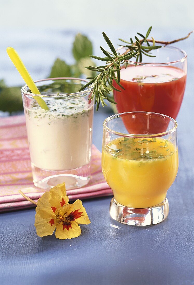 Yoghurt drink, orange juice and tomato juice with herbs