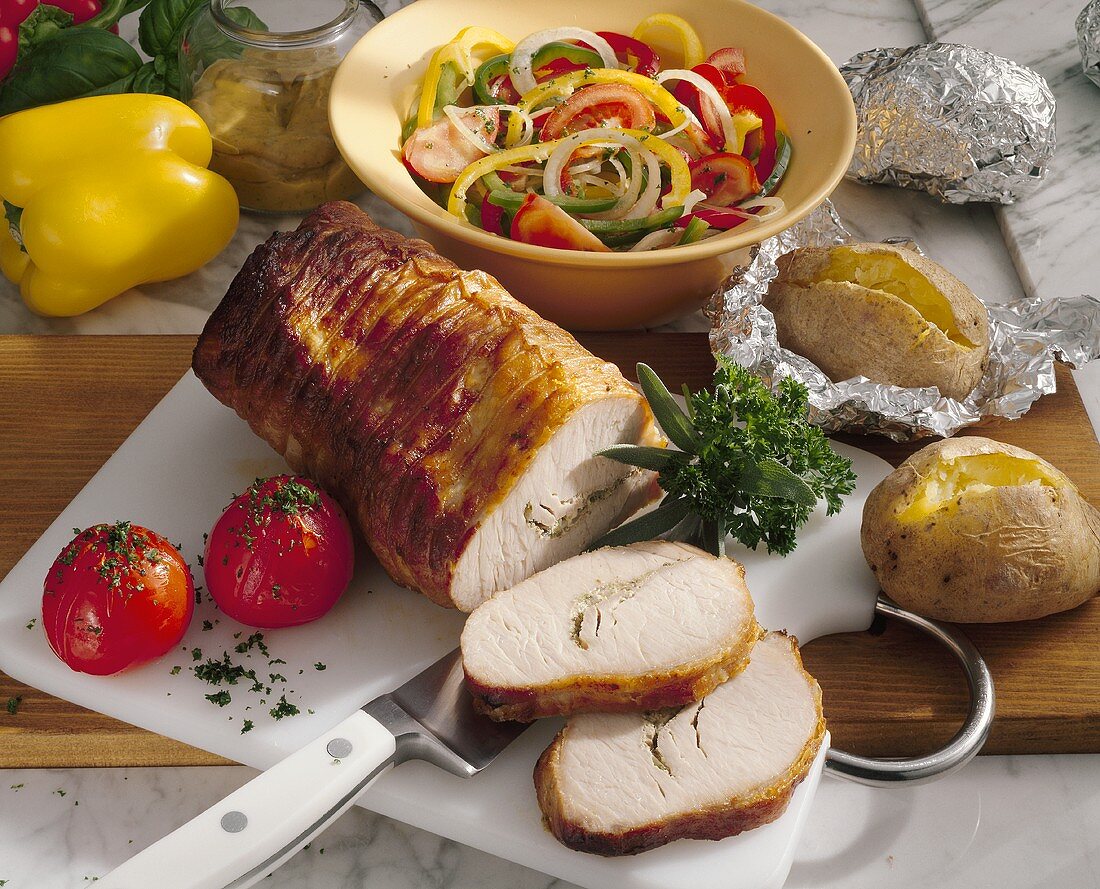 Mustard roasted pork with baked potatoes and pepper salad