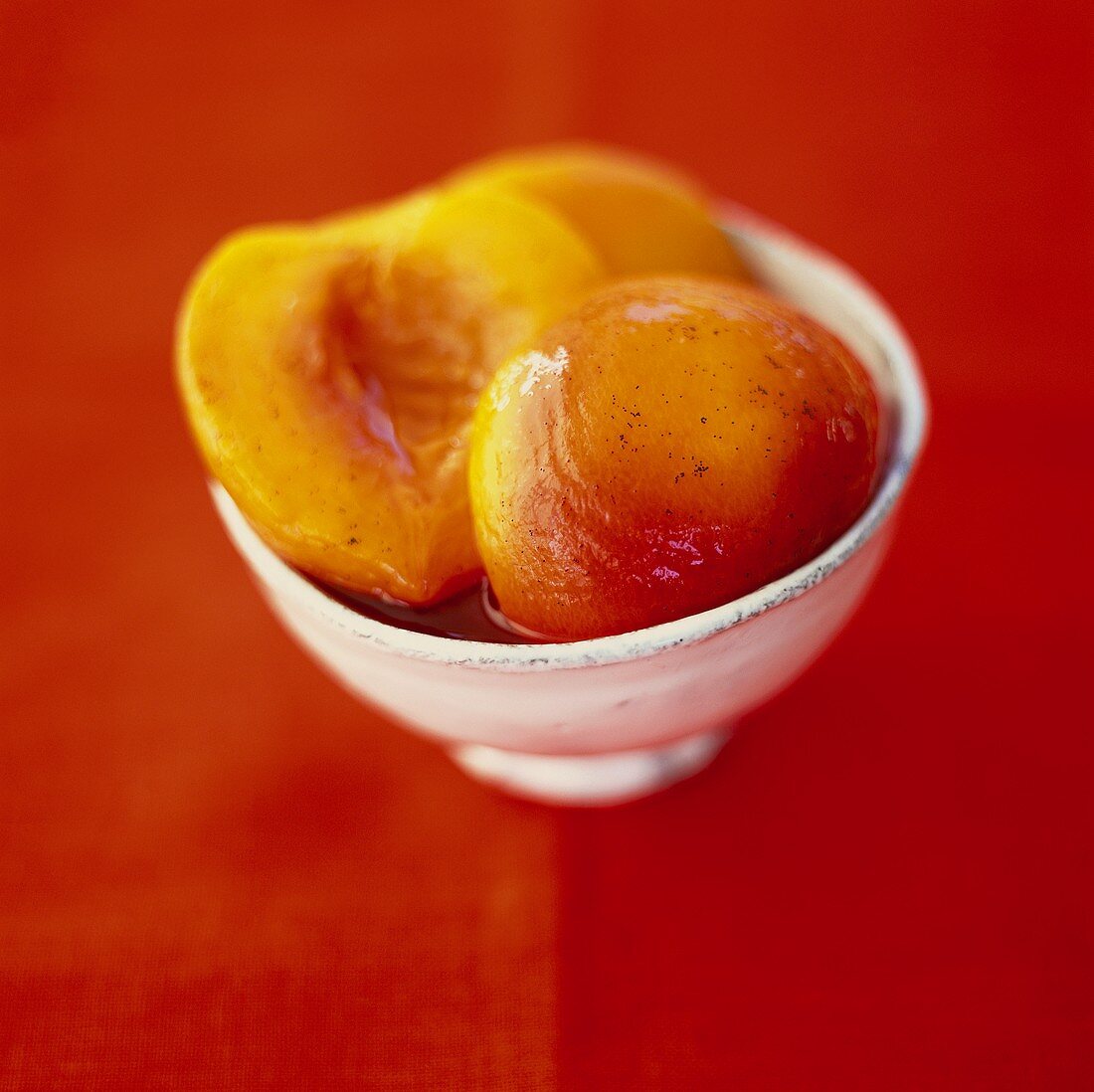 Peach compote in small white bowl